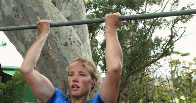 Dedicated Woman Performing Pull-Ups on Outdoor Bar - Download Free Stock Images Pikwizard.com