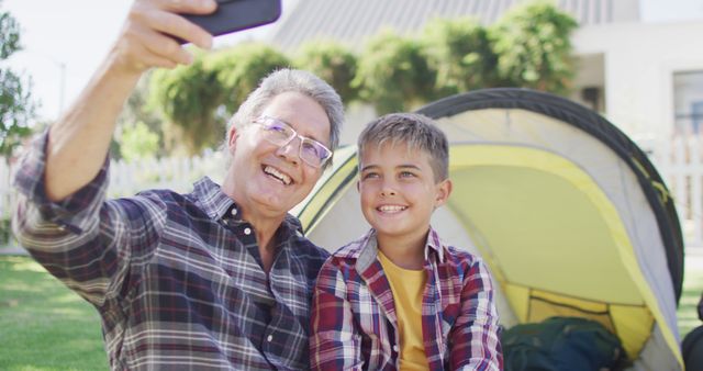 Father and Son Taking Selfies by Tent in Garden - Download Free Stock Images Pikwizard.com