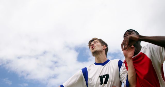 Soccer Players in Action Against Blue Sky - Download Free Stock Images Pikwizard.com