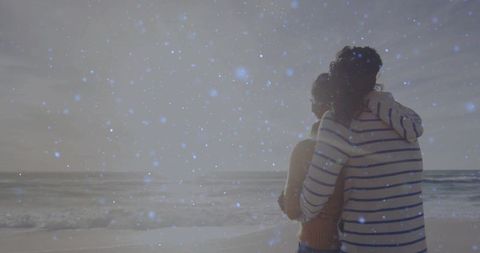 Romantic Couple Embracing on Tranquil Beach at Dusk