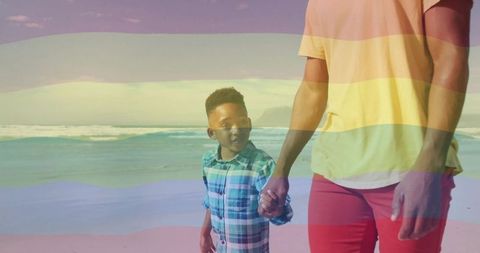 Father and Son Walking Hand in Hand on Beach with Rainbow Overlay Pastel Coastal Bonding