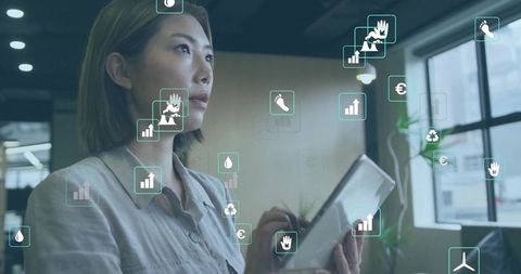 Businesswoman Analyzing Data with Sustainability Icons on Tablet