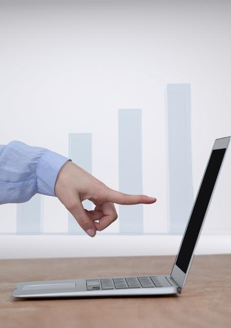 An image depicting a hand pointing at a laptop screen with bar charts incrementing in background. Ideal for illustrating concepts related to business growth, data analysis, finance trends, and technological progress.