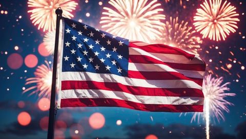 American flag waving amidst vibrant fireworks display