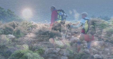 Mature Couple Hiking Rocky Trail with Backpacks and Trekking Poles