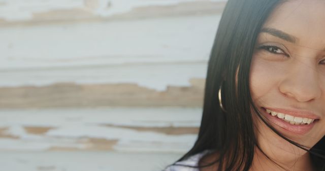 Close-Up of Young Woman Smiling with Peeling Paint Background - Download Free Stock Images Pikwizard.com