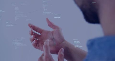 Developer interacting with transparent holographic interface and floating code in AR