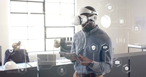 Man with VR Headset Holding Tablet in Modern Office