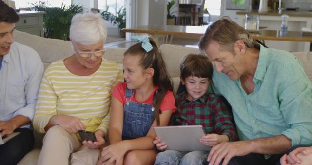 Three Generations Engaging with Digital Devices in Modern Living Room - Download Free Stock Images Pikwizard.com