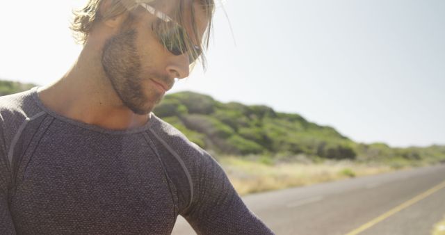 Athletic Man Resting on Rural Road During Sunny Day - Download Free Stock Images Pikwizard.com