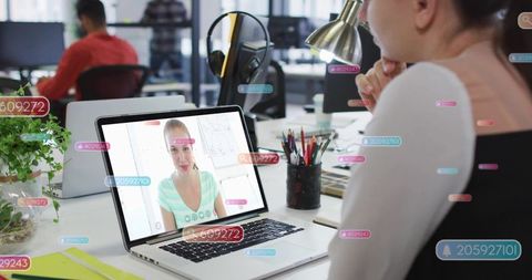 Joining remote video call at coworking desk with laptop and floating notification tags