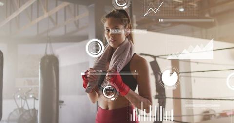 Female boxer cooling down in gym wearing red wraps with performance hud overlay