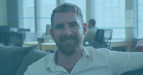 Businessman smiling with technology interface overlay