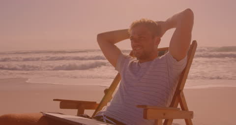 Man Relaxing on Chair at Serene Beach