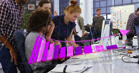 Diverse Colleagues Analyzing Data Visualizations on Computer in Modern Office