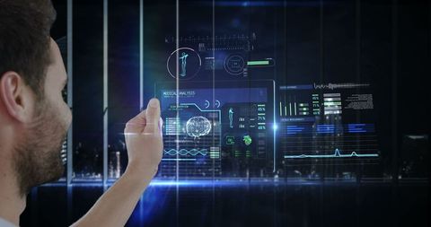 Man interacting with futuristic virtual interface in dimly lit environment