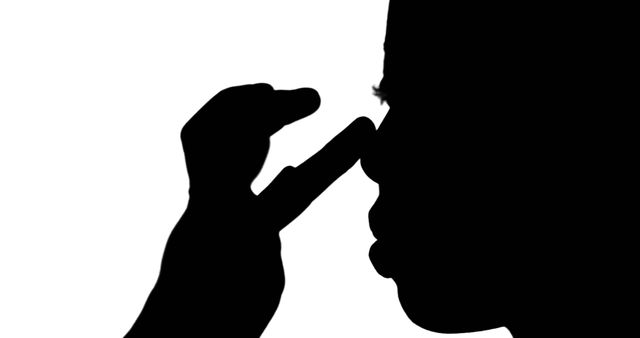 Silhouette of Relaxed Person Massaging Face with Hand in Minimalist Scene - Download Free Stock Images Pikwizard.com