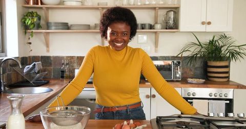 Smiling Woman in Rustic Kitchen Baking with Ingredients