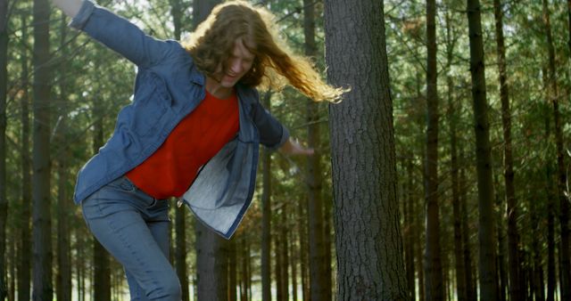Joyful Woman Balancing on Tree Trunk in Forest - Download Free Stock Images Pikwizard.com