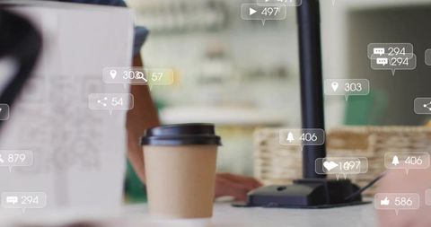 Takeaway coffee cup on workspace desk with social notifications overlay for remote work