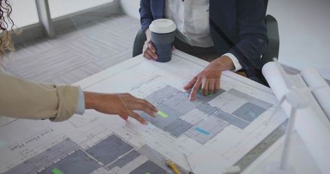 Architects Collaborating on Floor Plans with Modern Ideas