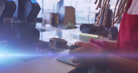 Barista preparing espresso in modern coffee shop
