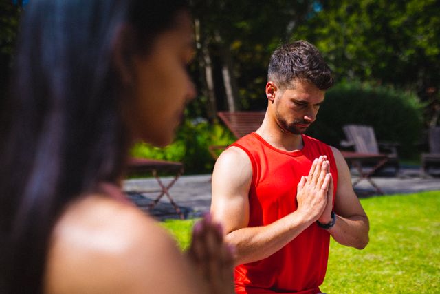 Caucasian young fit man and woman practicing yoga on sunny day. unaltered, fitness, yoga and healthy lifestyle.