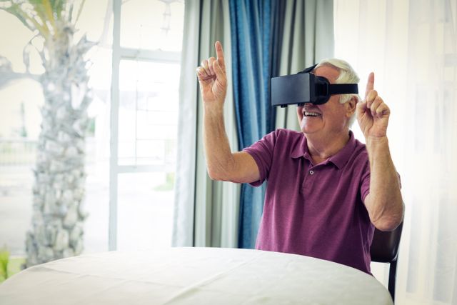 Senior man wearing virtual glasses at home