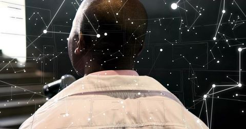 Presenter adjusting microphone wearing collared jacket with digital network overlay