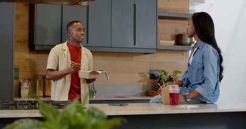 Couple Sharing Takeout and Conversation in Modern Kitchen