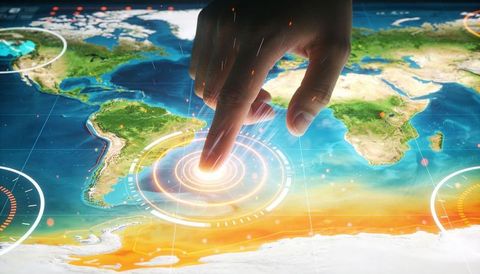Hand activating interactive global map hud with holographic data rings and analytics