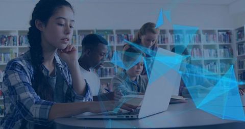 High school students collaborating with laptop and textbooks in modern library