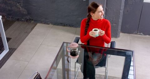 Businesswoman enjoying coffee break at modern office