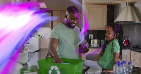 Father and daughter sorting recyclables in bright kitchen with neon light trails