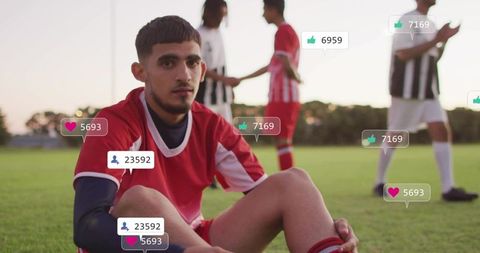 Overwhelmed soccer player sitting on sideline while social media likes and reactions pile
