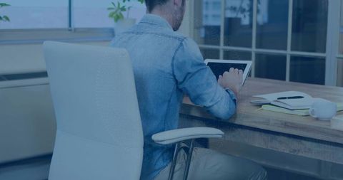 Casual Professional Using Tablet in Modern Office Setting