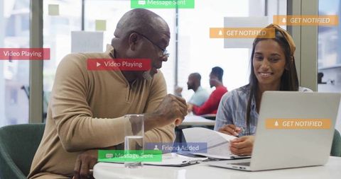 Senior Mentor Guiding Young Professional in Office Setting