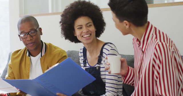 Diverse Group of Friends Smiling and Studying Together in Cozy Living Room - Download Free Stock Images Pikwizard.com