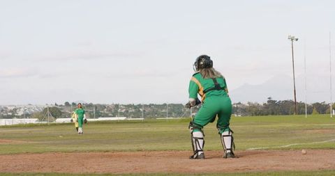 Female Wicketkeeper Ready for Action on Cricket Field