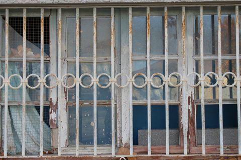 Rustic Window Frame With Weathered Iron Bars