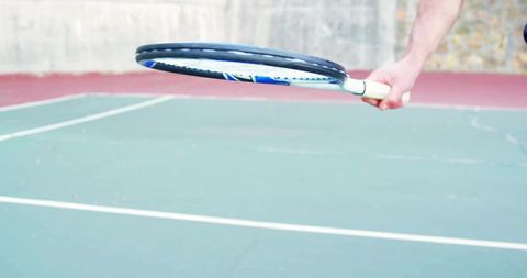 Tennis Player Swinging Racket on Outdoor Court