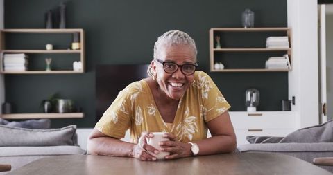 Smiling Senior African American Woman Relaxing at Home with Coffee