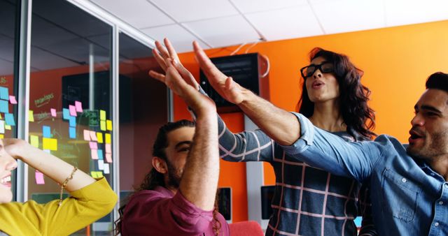 Office Team Celebrating Success with High-Five Gesture - Download Free Stock Images Pikwizard.com