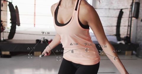Female skipping rope during dynamic cardio training in boxing gym, athletic workout studio
