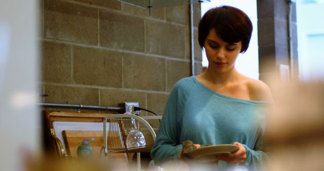 Young Woman Doing Dishes in Cozy Apartment - Download Free Stock Images Pikwizard.com