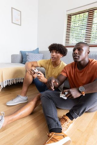 Diverse Friends Enjoying Video Game on Relaxed Weekend