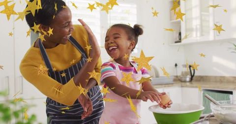 Joyful baking time with mother and daughter in kitchen