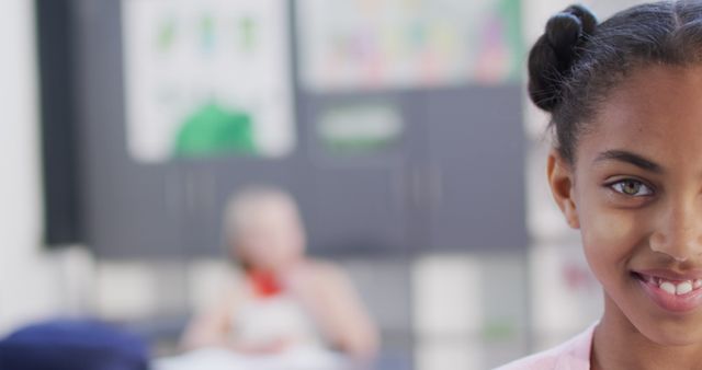 Diverse Girl Smiling in Classroom, Other Student in Background - Download Free Stock Images Pikwizard.com