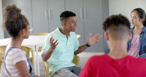 Diverse Teenagers in Group Discussion in Community Center