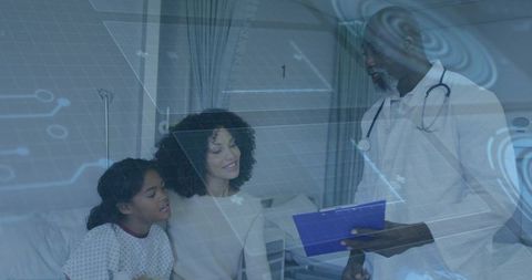 Doctor Consulting Smiling Mother and Daughter in Hospital Ward